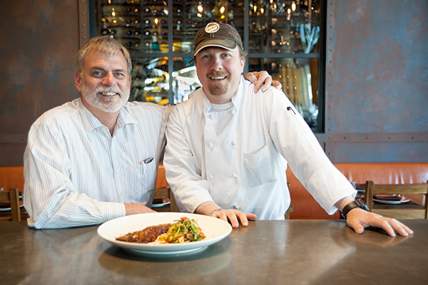 John Jackson (on left) and Rick Hackett with the Salt-Cured Ahi Tuna Tataki in the Bocanova dining room. Photo by Nicki Rosario 