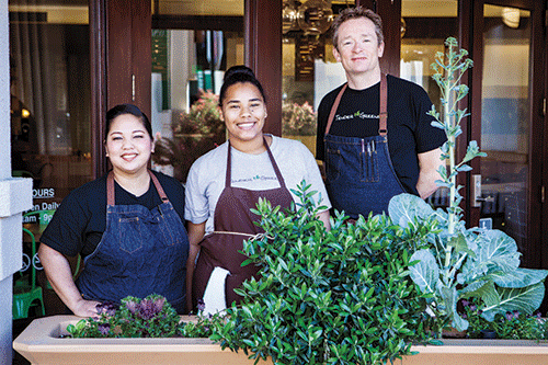 Tender Greens intern Caridad Johnson (center) has the benefits of enthusiastic mentoring from Sous Chef Som Saengsourith (left) and Chef Sean Eastwood.  