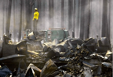 A worker surveys the devastation after the fire.